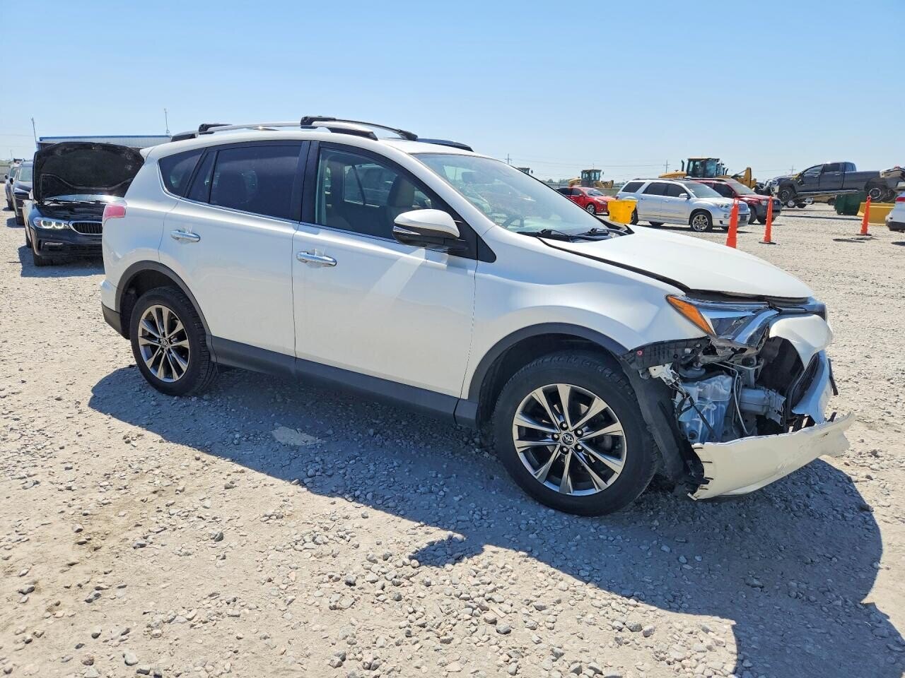 White Toyota RAV4 photographed with front damage at an auction yard